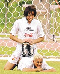 Uruguayan player Dario Silva stretches while being helped by team-mate