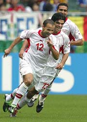 Tunisia�s Raouf Bouzaiene celebrates his goal against Belgium