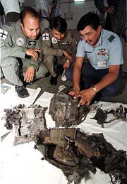 Pakistani air force officials examine the surveillance-pod from the wreckage of an Indian spy plane at a PAF base in Rawalpindi on Monday. 
