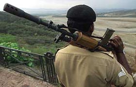 A paramilitary trooper keeps a vigil in front of the palace of former King of Kashmir Hari Singh