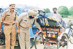 Mr H.S. Bhullar, DSP, adjusts a reflector on a rickshaw in SAS Nagar on Wednesday.