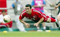 Hakan Unsal keeps his eyes on the ball as he flies through the air