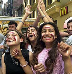 Teenagers, some who had skipped school in Istanbul on Thursday, celebrate 