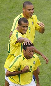 Brazil�s Junior  is congratulated by team-mates Rivaldo and Ronaldo