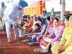 Devotees partake food at a �langar�