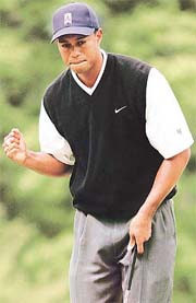 Tiger Woods reacts to his birdie