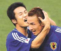 Japan�s Hidetoshi Nakata is hugged by team-mate