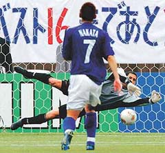 Tunisia�s goalkeeper Ali Boumnijel makes a save