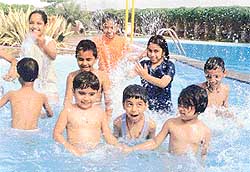 Children enjoy a splash in the pool 