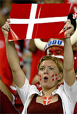 A Denmark fan holds a flag