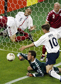 England's Rio Ferdinand watches from behind the net