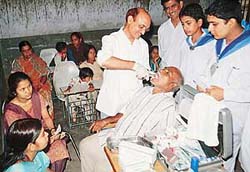 A dental doctor extracts a tooth of an aged patient of Kishangarh at a free medical camp in Chandigarh on Sunday.