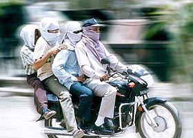 Four young men cover their faces