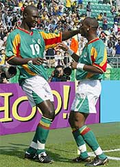 Senegal's Henri Camara celebrates with Papa Bouba Diop