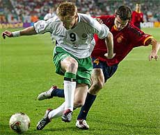 Spain's Ivan Helguera challenges Ireland's Damien Duff for the ball