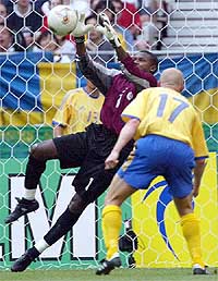 Senegal's goalkeeper Tony Sylva attempts a safe collection