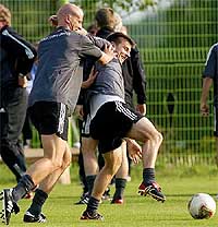 Germany's striker Carsten Jancker shares a light moment with midfielder Bernd Schneider 