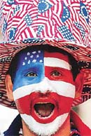 A US soccer fan with his face painted in the colors of the US flag