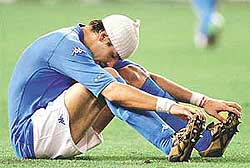 Italy's Francesco Coco sits dejected on the field 