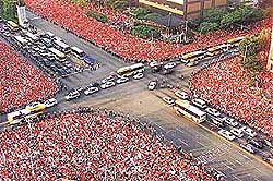 Tens of thousands of South Korean fans cheer their team in central Seoul