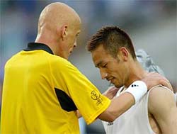 Referee Pierluigi Collina of Italy consoles Japan's Hidetoshi Nakata 