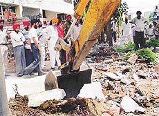 A JCB machine at work during an anti-encroachment drive launched by PUDA