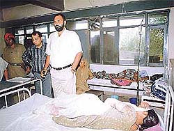 A police officer at the bedside of a girl who was allegedly stabbed by her boyfriend