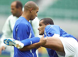 Brazil's Roberto Carlos (L) helps his team-mate Rivaldo stretch during practice at the Shizuoka stadium in Shizuoka on Thursday prior to the quarter-final match against England on Friday.