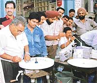 Members of the Dairy Development Department, Punjab, during a free milk testing camp