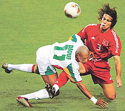 Senegal's El Hadji Diouf falls in front of Turkey's Bulent Korkmaz (R) during their World Cup quarter-final match in Osaka on Saturday.