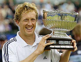 Sweden's Jonas Bjorkman lifts the winner's trophy after beating Australia's Wayne Arthurs in the men's singles final of the Samsung Open in Nottingham on Saturday.