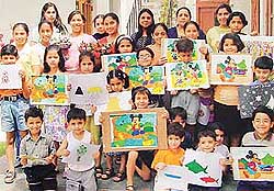 Participants of a summer workshop organised in Small Wonders Nursery School show their paintings