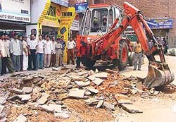 Tiles fixed by the Municipal Corporation of Chandigarh outside showrooms being uprooted by its own enforcement wing in Sector 28 on Tuesday.
