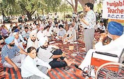 Punjab and Chandigarh teachers stage a dharna at the Matka chowk in Chandigarh on Tuesday.