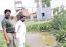 A resident of New Ashok Nagar points towards the park where dirty water gets collected and spreads diseases