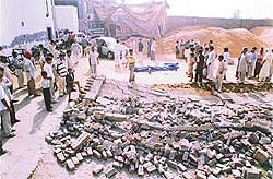 Debris of the collapsed wall and the bodies of two labourers