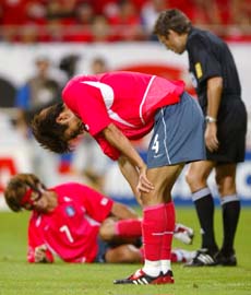 South Korea�s Choi Jin-Cheul (C) reacts after his team missed a scoring opportunity against Germany while Swiss referee Urs Meier (R) checks on Kim Tae-young during their semifinal in Seoul on Wednesday. 