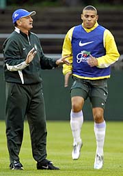 Brazilian head coach Luiz Felipe Scolari talks as striker Ronaldo (R) warms up during a training session in Saitama on Tuesday. 