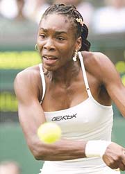 Defending champion Venus Williams of the USA plays a return to Britain's Jane O'Donoghue during their first round match at Wimbledon 