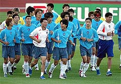 South Korean soccer players jog during a training session 