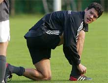 Germany midfielder Michael Ballack ties his shoes during training