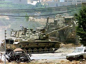 An Israeli tank moves toward the Palestinian Police building
