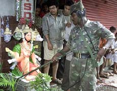 A soldier uses a bomb detector