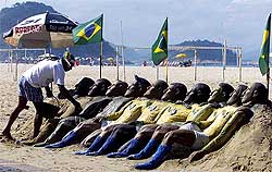 Sand sculptor Leopoldo Rios works on a creation