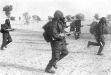 Indian jawans in nuclear, biological and chemical weapon-proof suits conduct exercises in the Rajasthan desert