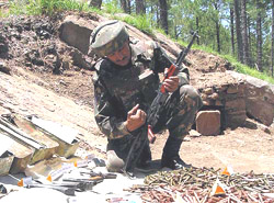 An Army jawan displays arms and ammunition
