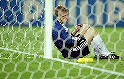 German goalkeeper Oliver Kahn looks down as he leans against the goalpost