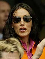 Wife of Britain's Greg Rusedski, Lucy, applauds during his match against Belgium's Xavier Malisse