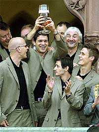 The players of the German national soccer team Carsten Jancker, Michael Ballack, Oliver Neuville, team manager Rudi Voeller and Sebastian Kehl, from left, celebrate on the balcony of the town hall