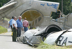 Investigators stand in front of the remains of a crashed Tupolev passenger plane near Brachenreute village on Wednesday, near the southern German town of Ueberlingen at Lake Constance.
